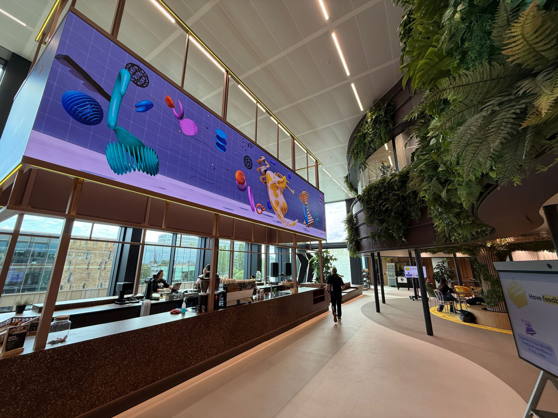 The Living Canvas screen above the café inside Miro100, Amsterdam